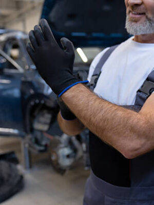Mechanic in service area in auto repair workshop